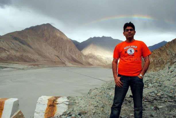 Dheeraj Sharma's friend with rainbow on the road to Nubra Valley from Khardung La in Leh - Ladakh